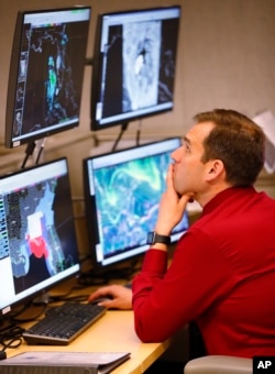 National Hurricane Center branch chief Michael Brennan monitors the status of Hurricane Michael, Tuesday, Oct. 9, 2018, at the Hurricane Center in Miami. (AP Photo/Wilfredo Lee)