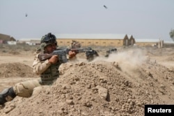 Iraqi soldiers train with members of the U.S. Army 3rd Brigade Combat Team, 82nd Airborne Division, at Camp Taji, Iraq, in this U.S. Army photo released June 2, 2015.