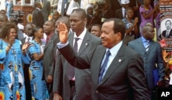 Cameroon's President Paul Biya waves to supporters during the opening of his party conference, in Yaounde, on September 15, 2011.