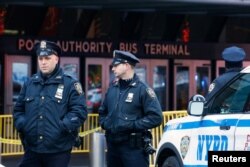 Police officers stand outside the New York Port Authority Bus Terminal in New York City, U.S. Dec. 11, 2017 after reports of an explosion.