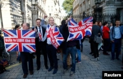 Vote Leave supporters wave Union flags, following the result of the EU referendum, outside Downing Street in London, Britain June 24, 2016.