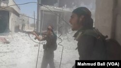 Syria Democratic Forces (SDF) fighters are seen engaged in a fire fight with Islamic State militants in Manbij, Syria, July 29, 2016.