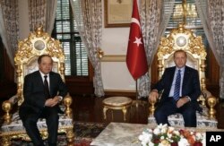FILE - Turkey's President Recep Tayyip Erdogan, right, and Iraqi Kurdish leader Massoud Barzani are seen prior to their meeting in Istanbul, Feb. 26, 2017. Ankara has been courting Barzani in its fight against the PKK and groups affiliated with it.