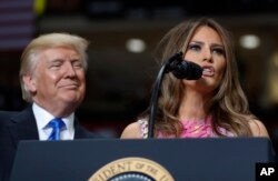 FILE - President Donald Trump looks to first lady Melania Trump as she introduces him during a rally at the Covelli Centre in Youngstown, Ohio, July 25, 2017.
