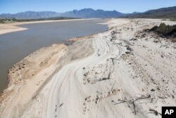 FILE - The Theewaterskloof Dam, a key source of water supply to Cape Town, South Africa, is shown at low levels, April 16, 2017.