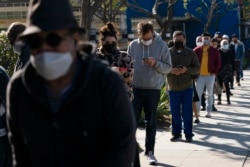 People wait in line for a COVID-19 test in Los Angeles, California, Jan. 4, 2022.