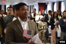 Chijioke Anyira, from Nigeria, awaits the administration of oath. “I hold it in very high esteem to be an American,” said Anyira, after the ceremony. (R. Taylor/VOA)