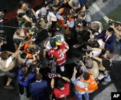 Atlanta Falcons quarterback Matt Ryan (2) embraces Green Bay Packers quarterback Aaron Rodgers (12) after the NFL football NFC championship game Sunday, Jan. 22, 2017, in Atlanta.
