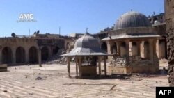 Unverified image from Youtube video allegedly showing rubble of minaret (background) of Aleppo's ancient Umayyad mosque