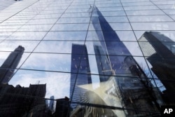 One World Trade Center is reflected in the windows of the National September 11 Museum, Thursday, March 30, 2017, in New York. (AP Photo/Mark Lennihan)