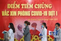 FILE PHOTO: Health workers wait for their turn as Vietnam starts its official rollout of AstraZeneca's coronavirus disease (COVID-19) vaccine for health workers, at Hai Duong Hospital for Tropical Diseases, Hai Duong province, Vietnam, March 8, 2021.