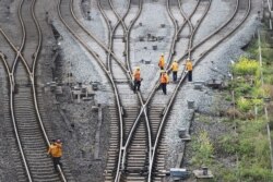 FILE - Workers inspect railway tracks for the Belt and Road freight rail route linking Chongqing, China, with Duisburg, Germany, at the Dazhou railway station in Sichuan province, China, March 14, 2019. (Reuters)