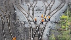 FILE - Workers inspect railway tracks for the Belt and Road freight rail route linking Chongqing, China, with Duisburg, Germany, at the Dazhou railway station in Sichuan province, China March 14, 2019.