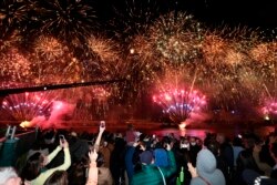 People celebrate in Brisbane, Australia, Wednesday, July 21, 2021, following an announcement by the International Olympic Committee that Brisbane was picked to host the 2032 Olympics.