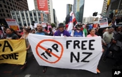 FILE - Protesters march to the venue of the Trans-Pacific Partnership signing in Auckland, New Zealand, Feb 4, 2016.