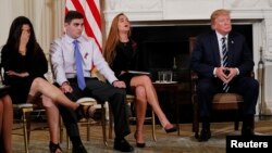 Marjory Stoneman Douglas High School shooting surviving students Jonathan Blank, 2nd from left, and Julia Cordover, as well as Jonathan's mother Melissa Blank, left, listen along with President Donald Trump during a listening session at the White House.
