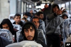 Migrants sit on a bus going to Normandy, as they leave the makeshift migrant camp known as "the jungle" near Calais, northern France, Oct. 24, 2016.