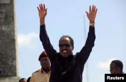 FILE - Somalia's President Hassan Sheikh Mohamud waves to the guests as he arrives for Independence Day celebrations outside the ruins of the former parliament buildings in Somalia's capital, Mogadishu, July 1, 2016.