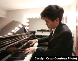 Daniel Hsu of the United States warms up in his dressing room before performing his Thursday evening recital in the Semifinal Round at the 15th Van Cliburn International Piano Competition.