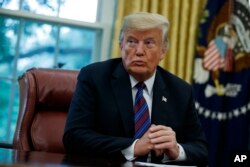 President Donald Trump talks on the phone with Mexican President Enrique Pena Nieto, in the Oval Office of the White House, Aug. 27, 2018, in Washington.