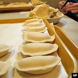 Volunteers scoops out the smooth potato filling to make tray after tray of hand-shaped pierogies in time for Orthodox Christmas.
