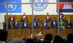FILE - Judges arrive at the Extraordinary Chambers in the Courts of Cambodia in Phnom Penh, Cambodia, as the trial for former Khmer Rouge prison commander Kaing Guek Eav, also know as "Duch" begins Tuesday, Feb. 17, 2009, in Phnom Penh, Cambodia.