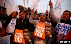 FILE - People attend a rally demanding the release of former President Alberto Fujimori in Lima, Peru, July 22, 2016.