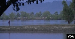 Bangladesh border guards patrol the shore of the Naf River opposite Myanmar's Rakhine state. (S. Sandford/VOA)