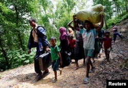 Orang Rohingya berjalan menuju tempat penampungan darurat dekat perbatasan Bangladesh-Myanmar, setelah dilarang oleh anggota Penjaga Perbatasan Bangladesh (BGB), untuk memasuki Bangladesh, di Cox’s Bazar, Bangladesh, 28 Agustus 2017.