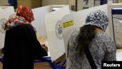 FILE - Muslim Bangladeshi Americans vote for the U.S. presidential election in the Queens borough of New York, Nov. 8, 2016.
