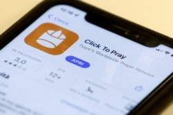 The 'Click to Pray' app is a smartphone app designed to allow the faithful to pray with a click. Here it is seen on a mobile phone. (REUTERS/Guglielmo Mangiapane/Illustration)
