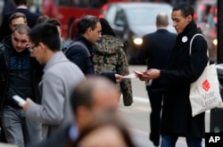 A pro-Brexit campaigner hands out leaflets at Liverpool Street station in London.