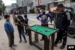Palestinian boys play pool in the Rafah refugee camp in the southern Gaza Strip.