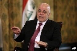 Iraq's Prime Minister Haider al-Abadi speaks during an interview with The Associated Press in Baghdad, Iraq, Sept. 16, 2017.