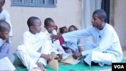 Usman Mohammed, right, was an almajiri many years ago. Now he is an activist, trying to reform a system that he sees as degrading and abusive.