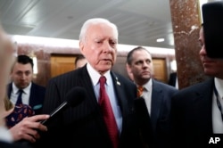 FILE - Senate Health, Education, Labor and Pensions Committee member Sen. Orrin Hatch, center, leaves the committee's executive session, on Capitol Hill in Washington, Jan. 31, 2017.