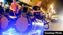 Longtime Bike Party volunteer Danny Lesh stands next to his "sound bike" -- a speaker system that he built himself and attached to his bike..