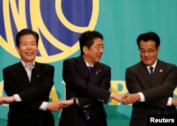 Japan's Prime Minister and leader of the ruling Liberal Democratic Party (LDP) Shinzo Abe (C), the leader of the Democratic Party Katsuya Okada (R) and Komeito party leader, Natsuo Yamaguchi, attend a debate with rival party leaders ahead of July 10 upper house election in Tokyo, June 21, 2016.