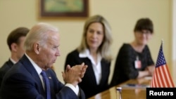U.S. Vice President Joe Biden (L) speaks during meeting with Latvia's President Andris Berzins (not pictured) in Vilnius March 19, 2014.