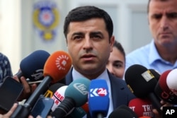 FILE - Pro-Kurdish Peoples' Democracy Party leader Selahattin Demirtas speaks to the media about Turkey's airstrikes against Kurdish rebel bases in Iraq, in Ankara, Turkey, July 27, 2015.