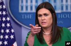White House press secretary Sarah Huckabee Sanders calls on a reporter during the daily briefing at the White House in Washington.