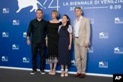 Actors Kristen Wiig, from left, Matt Damon, Hong Chau and director Alexander Payne pose for photographers at the photo call of the film "Downsizing" during the 74th edition of the Venice Film Festival in Venice, Italy, Aug. 30, 2017.