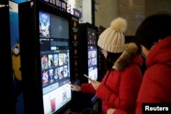 지난 1월 중국 톈진의 한 극장에서 관람객들이 자동매표기를 이용해 영화표를 구입하고 있다.