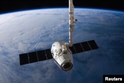 FILE - The SpaceX Dragon cargo capsule approaches the International Space Station prior to installation in this NASA picture taken April 10, 2016.