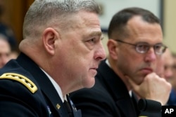 Army Chief of Staff Gen. Mark A. Milley, accompanied by Chief of Naval Operations Adm. John M. Richardson, testifies on Capitol Hill in Washington, April 5, 2017.