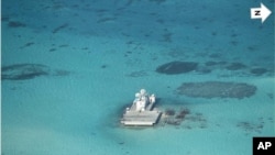 In this photo taken Feb. 28, 2013 by a surveillance plane, and released Thursday, May 15, 2014, by the Philippine Department of Foreign Affairs, Chinese-made structures stand on the Johnson Reef, called Mabini by the Philippines and Chigua by China.