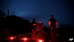 A man talks with officers at a roadblock less than three miles from the Arkema Inc. chemical plant, Aug. 31, 2017, in Crosby, Texas.