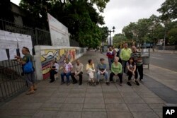 People wait to enter a poll station to cast their ballot during Mayoral Elections in Caracas, Venezuela, Dec. 10, 2017.