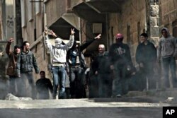 FILE - Anti-Syrian government demonstrators take to the streets in the southern city of Daraa, March 23, 2011.