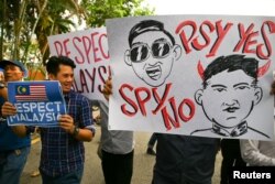 Members of the youth wing of the National Front, Malaysia's ruling coalition, hold placards during a protest at the North Korean Embassy, following the killing of Kim Jong Nam, in Kuala Lumpur, Malaysia, Feb. 23, 2017.